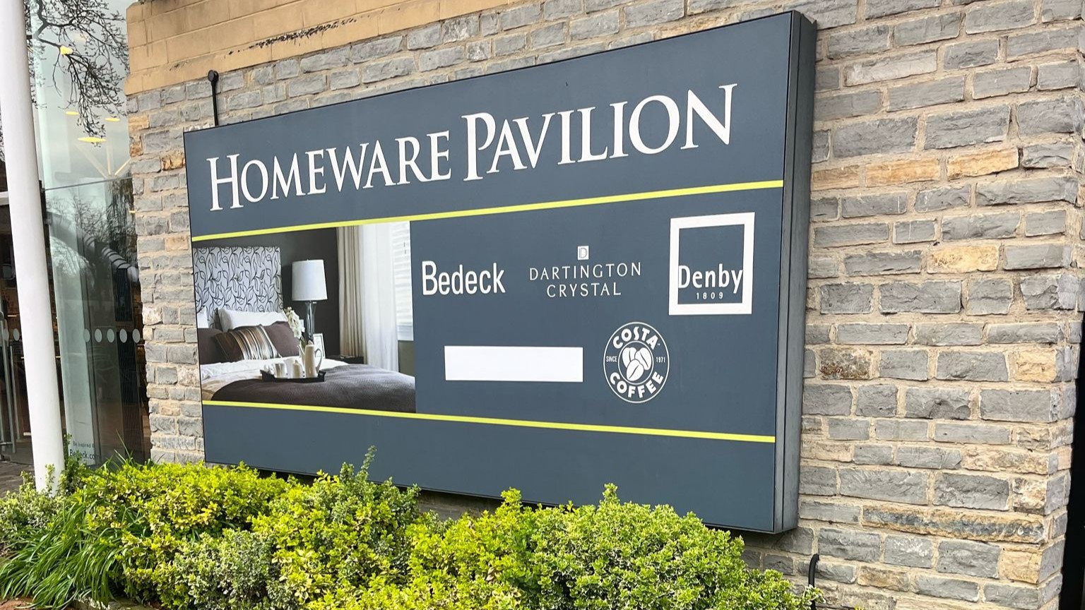 An illuminated sign featuring Homeware Pavillion